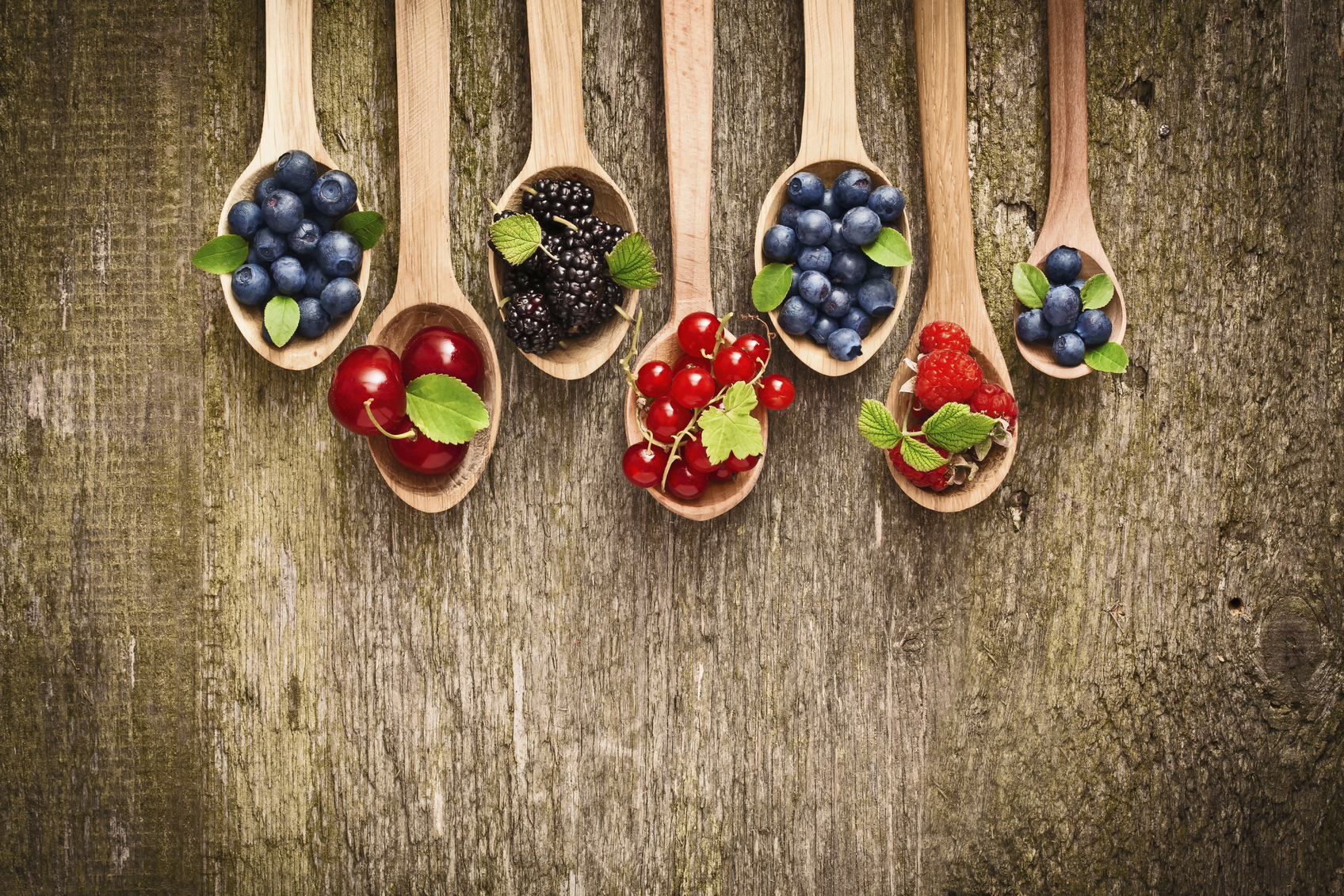 Berries in wooden spoons